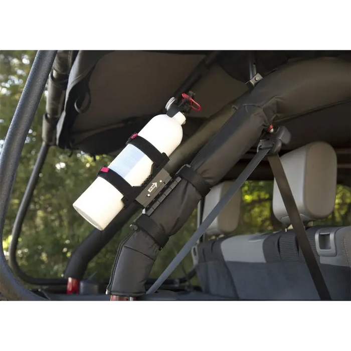 Rear seat of a car with a bottle, Jeep Wrangler fire extinguisher holder.