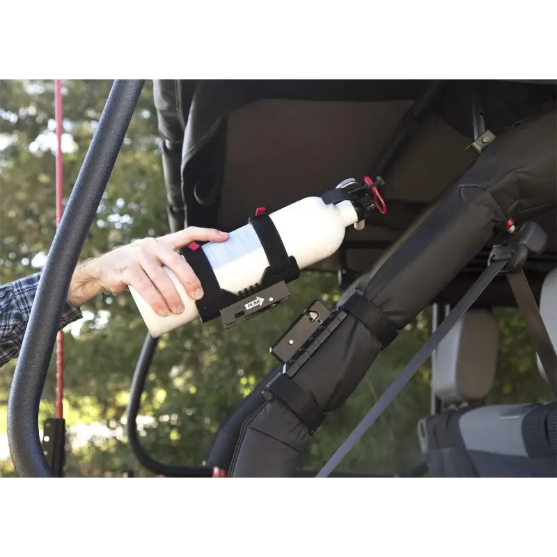Man holding bottle in hand with Rugged Ridge Jeep Wrangler Elite Fire Extinguisher Holder.