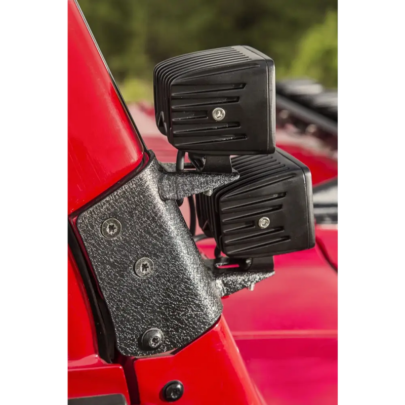Rugged Ridge 97-06 Jeep Wrangler TJ Textured Black Dual A-Pillar Light Mount with black plastic door latches on red car