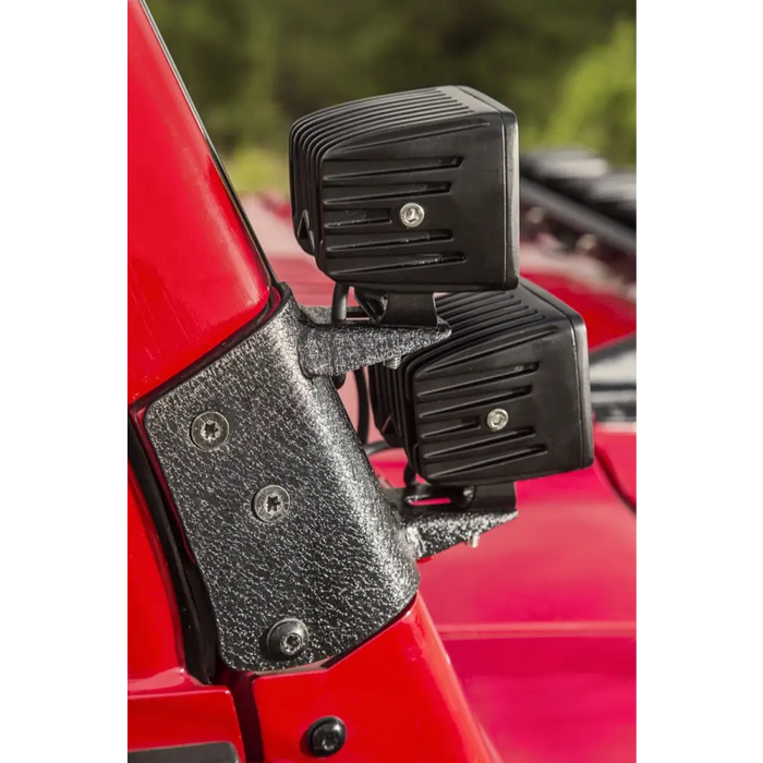 Rugged Ridge 97-06 Jeep Wrangler TJ Textured Black Dual A-Pillar Light Mount with black plastic door latches on red car