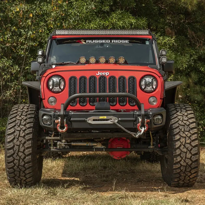 Rugged Ridge Arcus Front Bumper Tube Overrider Black JK parked in field.