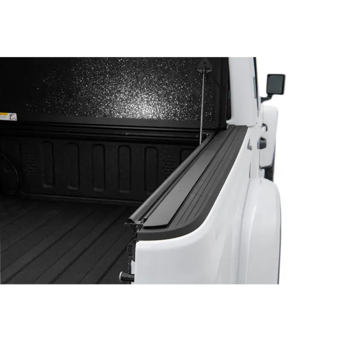 Rugged Ridge Armis Hard Folding truck bed cover with black design.