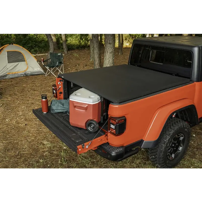 Rugged Ridge Armis Soft Folding Bed Cover with cooler and camping tent in the back.