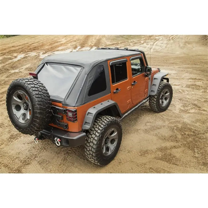 Rugged Ridge Bowless Soft Top Black Diamond 4-Door Jeep Wrangler JK parked on dirt