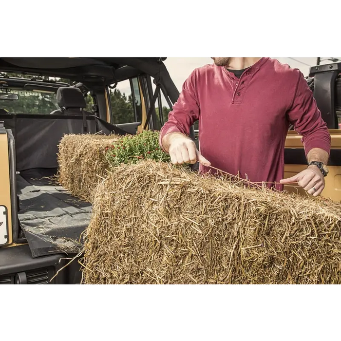 Man loading hay into truck - Rugged Ridge C3 Cargo Cover for Jeep Wrangler JKU