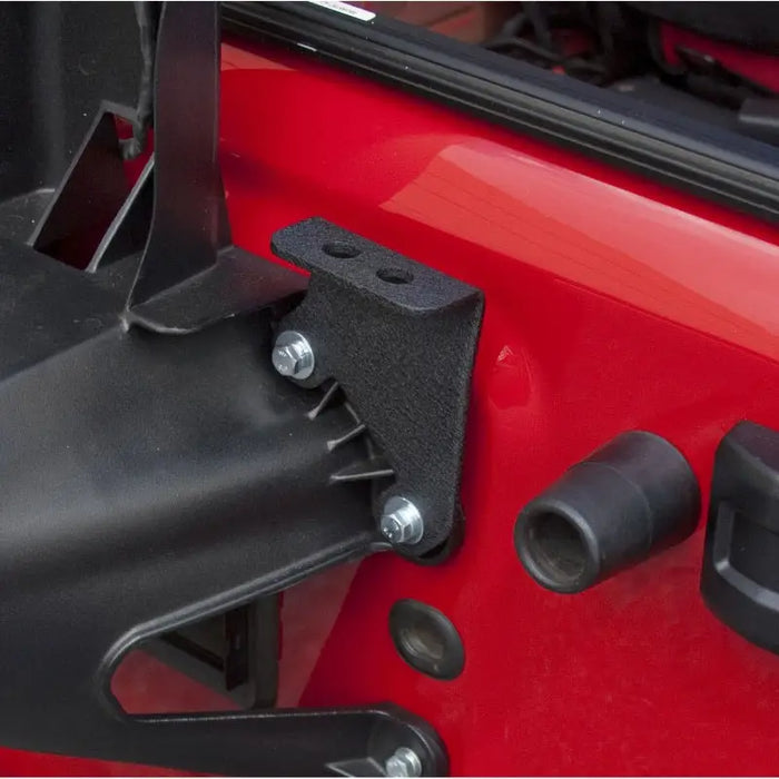 Rugged Ridge CB Antenna Mount attached to red Jeep Wrangler tire carrier.