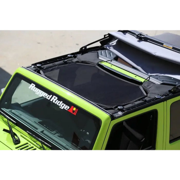 Front roof rack mounted on Jeep Wrangler JK with Rugged Ridge Eclipse sun shade.