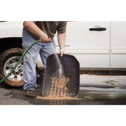 Man cleaning tire with Rugged Ridge floor liner for Jeep Wrangler.