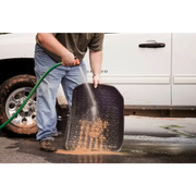 Man cleaning tire with hose - Rugged Ridge Floor Liner for Jeep Wrangler Unlimited JK 4 Dr.