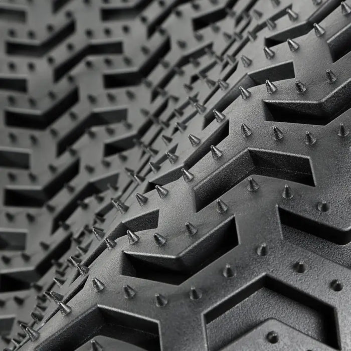 Rugged Ridge Floor Liner displaying bicycle tire tread.