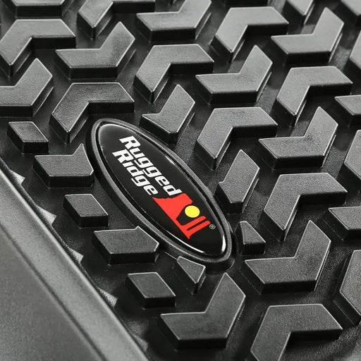 Rugged Ridge logo on black car displayed on floor liner for Jeep Wrangler JK 2 Dr.