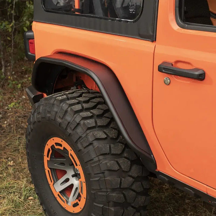 Rugged Ridge HD Steel Tube Fenders Full Set Black 18-19 JL featuring a jeep with orange wheels and tires