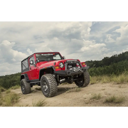 Rugged Ridge Hurricane Flat Fender Flares on Jeep Wrangler TJ parked on dirt road.