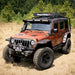 Rugged Ridge Hurricane Flat Fender kit on Jeep with roof rack in field.