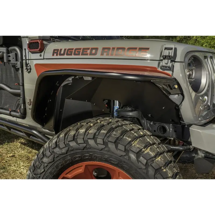 Front bumper mounted on Rugged Ridge aluminum fender liners for Jeep Wrangler JL.