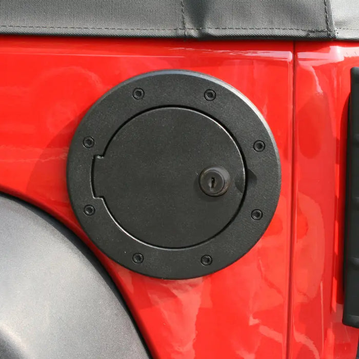 Close-up of red Jeep Wrangler JK door handle gas cap.