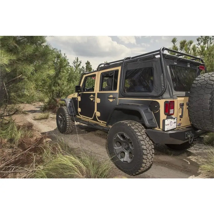 Jeep parked on dirt road showcasing Rugged Ridge Magnetic Protection Panel kit for Wrangler.