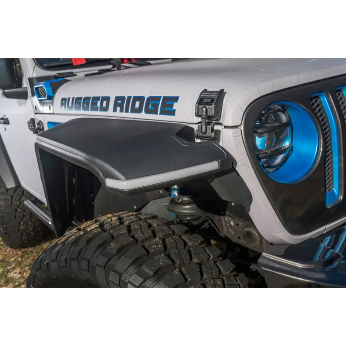 Rugged Ridge Max Terrain fender flare set on blue and white decal Jeep Wrangler.