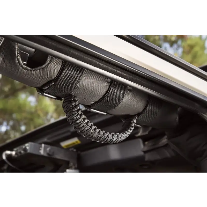 Rear view of vehicle with open car rear window, featuring Rugged Ridge Paracord Grab Handles.