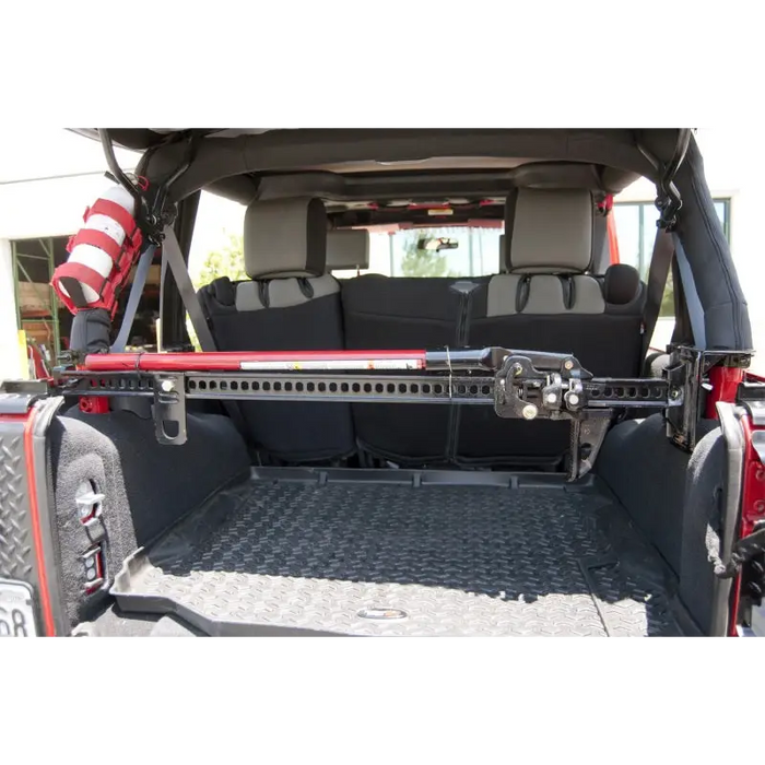 Rear view of Jeep with cargo door open, Rugged Ridge roll bar mounting bracket.