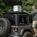 Man installing tire on Jeep with Rugged Ridge Roof Rack for 18-20 Jeep Wrangler JL 4Dr Hardtops