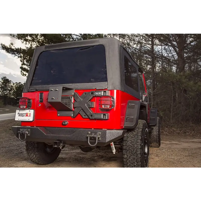 Red Jeep with black top parked on dirt - Rugged Ridge Spartacus HD Tire Carrier Hinge Casting 97-06 TJ