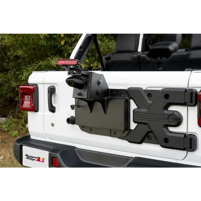Rugged Ridge Spartacus HD Tire Carrier Kit mounted on back of a Jeep with camera