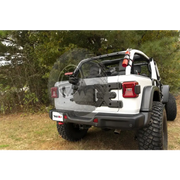 White Jeep with black bumper and tire carrier from Rugged Ridge Spartacus HD Tire Carrier Wheel Mount for 18-20 Jeep Wrangler JL.