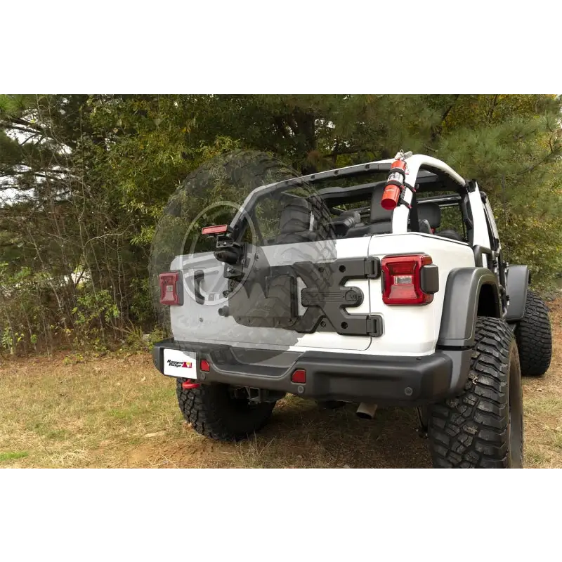 White Jeep with black bumper and tire carrier from Rugged Ridge Spartacus HD Tire Carrier Wheel Mount for 18-20 Jeep Wrangler JL.