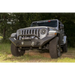 Rugged Ridge Spartan Front Bumper HCE W/Overrider on Jeep Wrangler in Field.