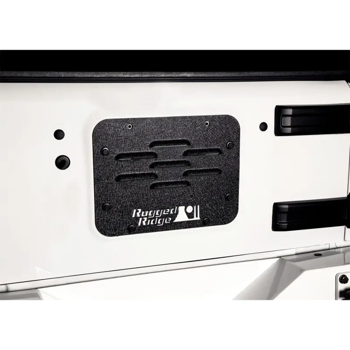 Rugged Ridge spare tire delete plate with logo on rear door panel.