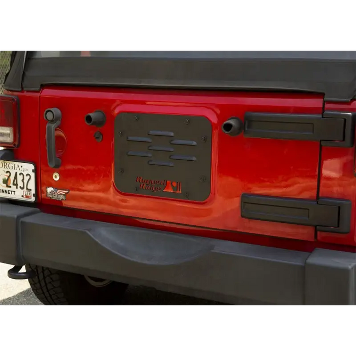 Red Jeep with black license plate on Rugged Ridge Tire Carrier Delete Plate 07-18 Jeep Wrangler JK