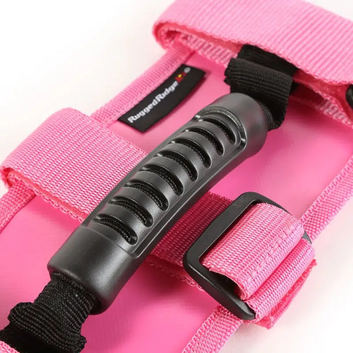 Pink camera strap with black handle on Rugged Ridge Ultimate Grab Handles.