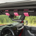 Rugged Ridge Ultimate Grab Handles Pink - Interior of a Jeep with Pink Seat Belt