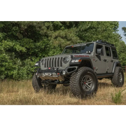 Rugged Ridge Venator front bumper on Jeep Wrangler parked in field.