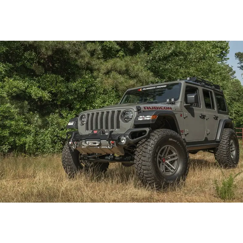 Rugged Ridge Venator front bumper on Jeep Wrangler parked in field.