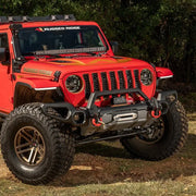 Red Jeep Wrangler with Venator Front Bumper Overrider parked in field