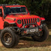 Red Jeep Wrangler with Venator Front Bumper Overrider parked in field
