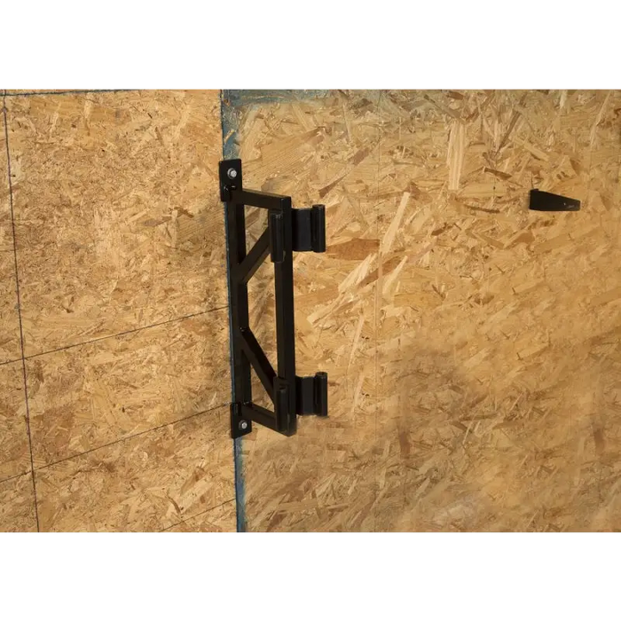 Rugged Ridge Wall Mount Door Holder with black metal hook on wooden wall.