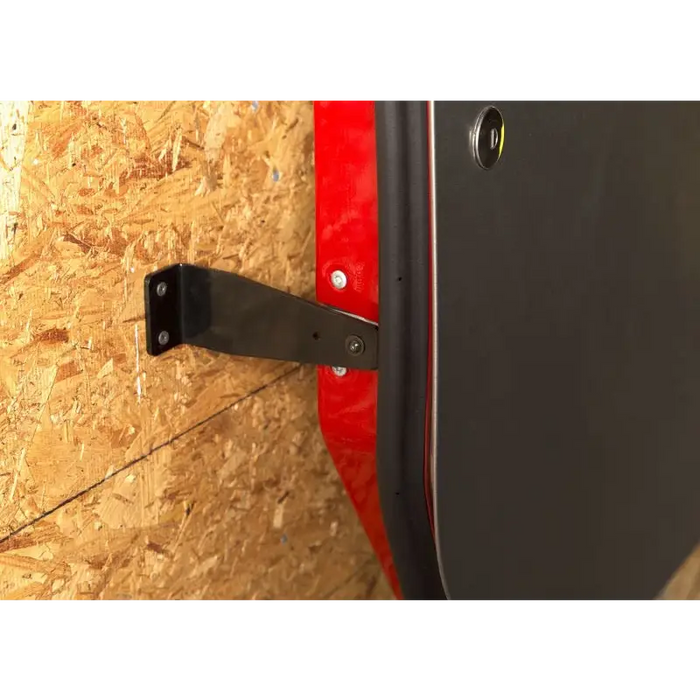 Rugged Ridge Wall Mount Door Holder with red and black metal door handle.
