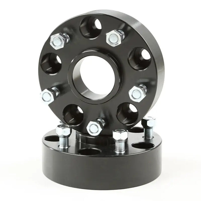 Rugged Ridge black wheel spacers with four bolts.