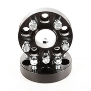 Black wheel hub with four spokes designed for Rugged Ridge Wheel Spacers.