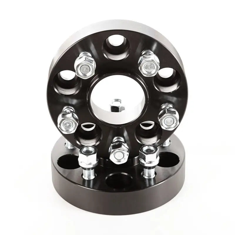 Black wheel hub with four spokes designed for Rugged Ridge Wheel Spacers.