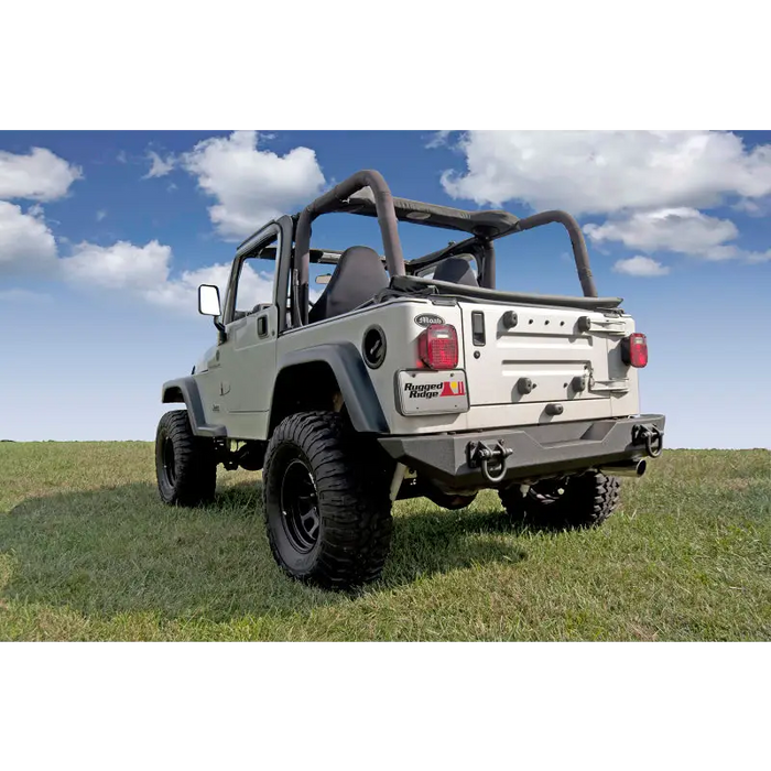 Jeep parked in grass near Rugged Ridge XHD Rear Bumper.