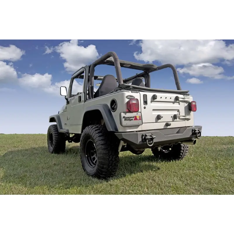 Rugged Ridge XHD Rear Bumper for Jeep parked in grass