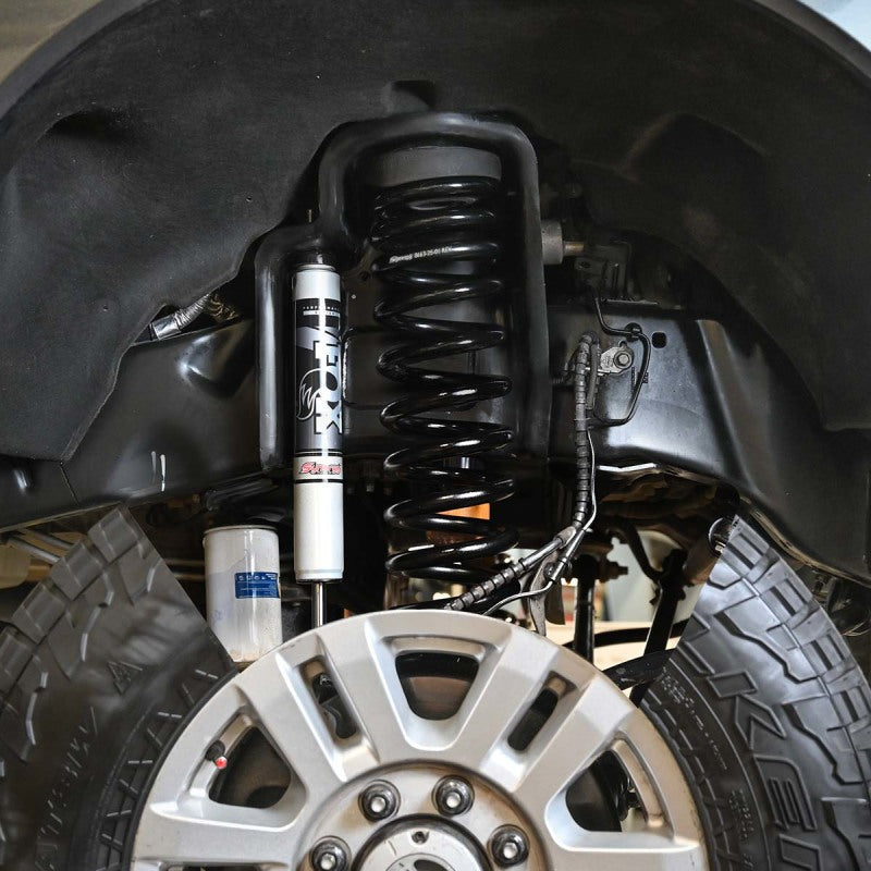 Ford super duty f-250/f-350ax4 diesel leveling system with rear-mounted front suspension