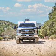 Blue ford super duty f-250 truck parked on dirt road