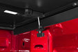 Red truck with black bed and ceiling under tonno pro tri-fold tonneau cover