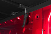 Tonno pro tri-fold tonneau cover for 16-19 toyota tacoma: red truck with black door handle