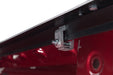 Red metal door latch on tonno pro lo-roll tonneau cover